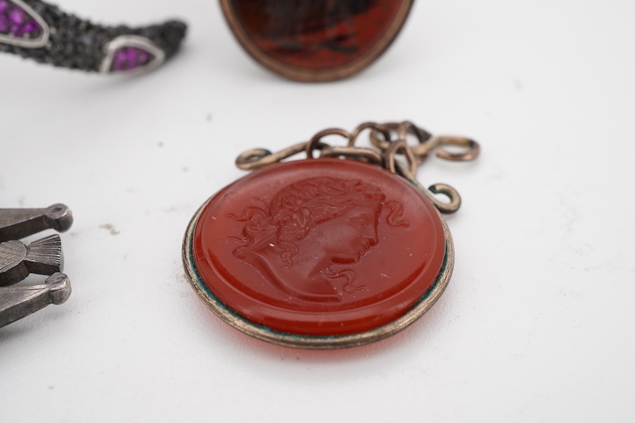 A collection of jewels including a snake bracelet, comprising: a hinged bangle modelled as a snake in silver, pavé-set with circular-cut black sapphires and synthetic rubies, its tongue a marquise-shaped synthetic ruby,